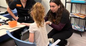 UT School of Nursing students administer a hearing exam with a Child Development Center learner